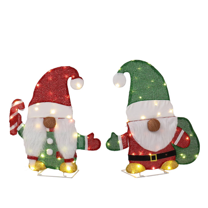 Two lit Christmas gnome figures in garden