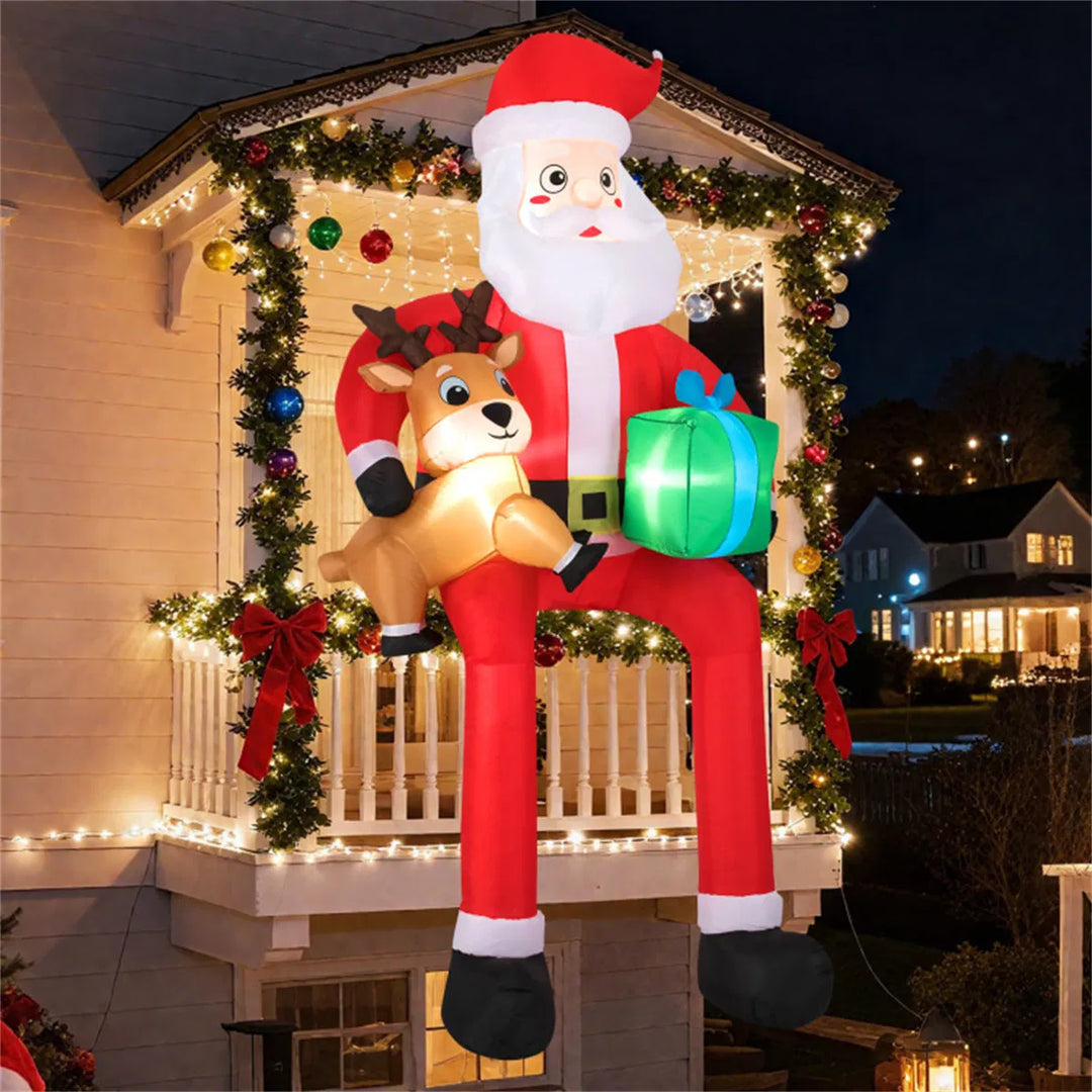 Giant inflatable Santa sitting with reindeer