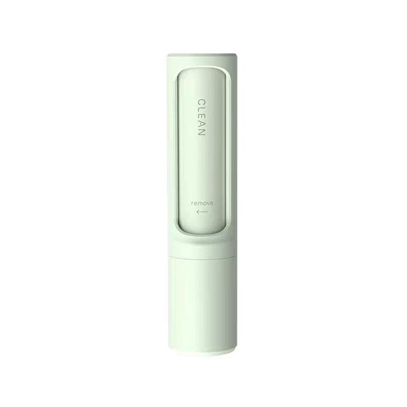 Pet hair remover brush on grey sofa