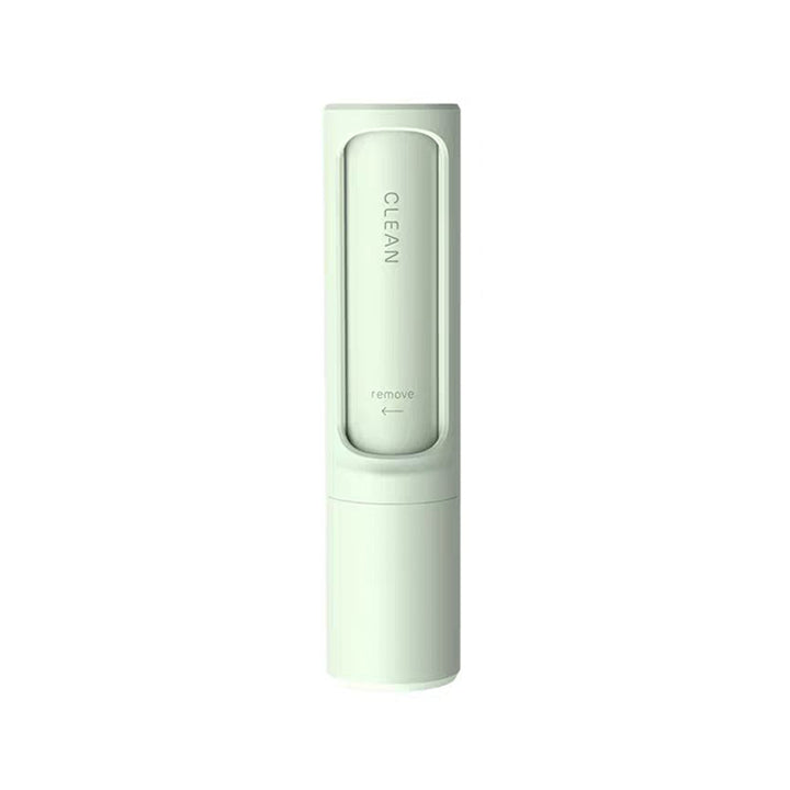 Pet hair remover brush on grey sofa