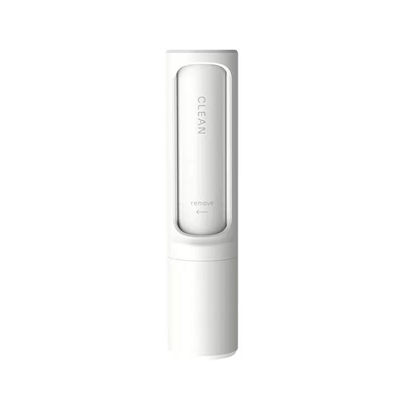 Pet hair remover brush on grey sofa