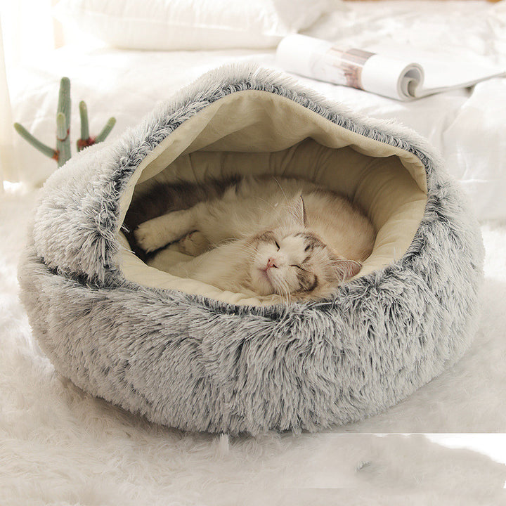 Cat curled in round plush hooded pet bed