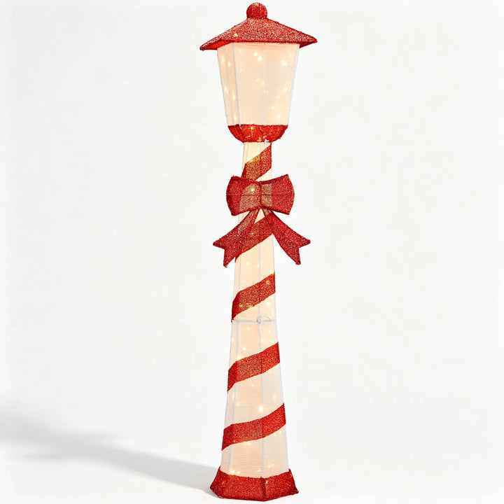 Candy cane striped Christmas lamp post glowing