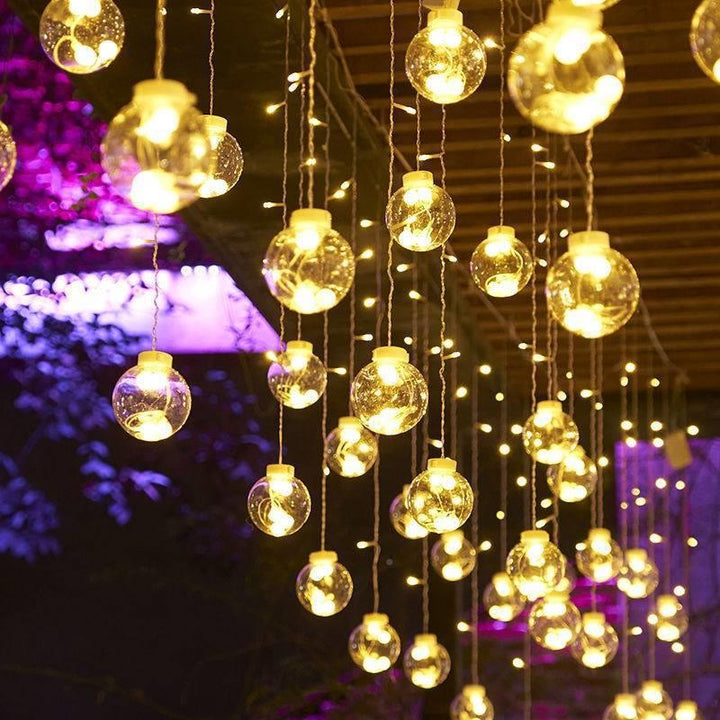 Warm white LED orb curtain lights in window