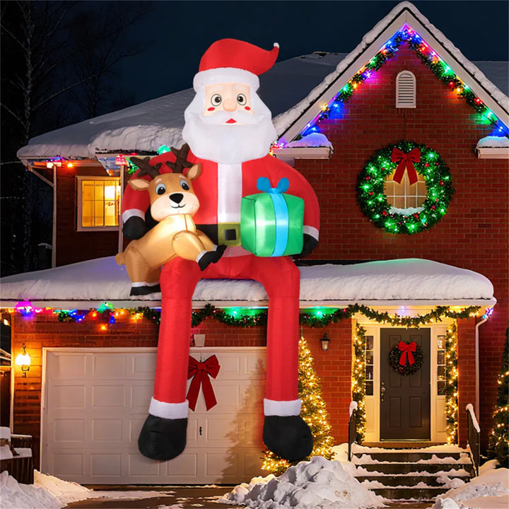 Giant inflatable Santa sitting with reindeer