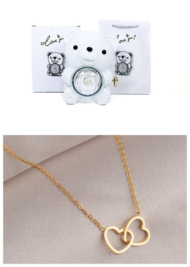Rotating teddy bear jewellery box with eternal rose