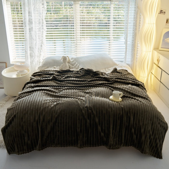 Dusty rose ribbed faux fur blanket on bed