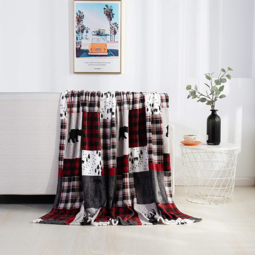 Christmas fleece throw blanket on a sofa