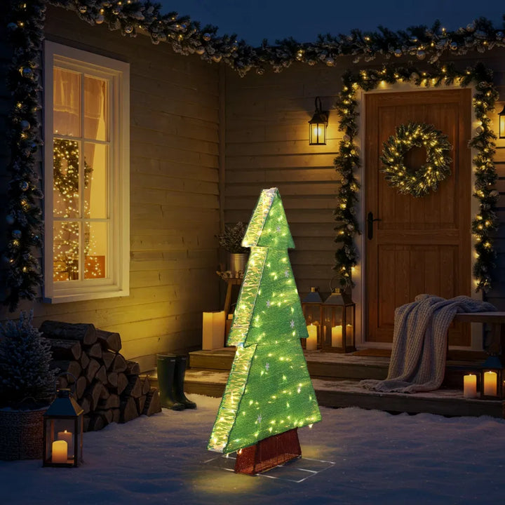 Lit tinsel Christmas tree silhouette outdoors