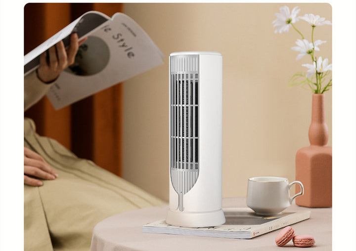 White compact tower fan heater on desk