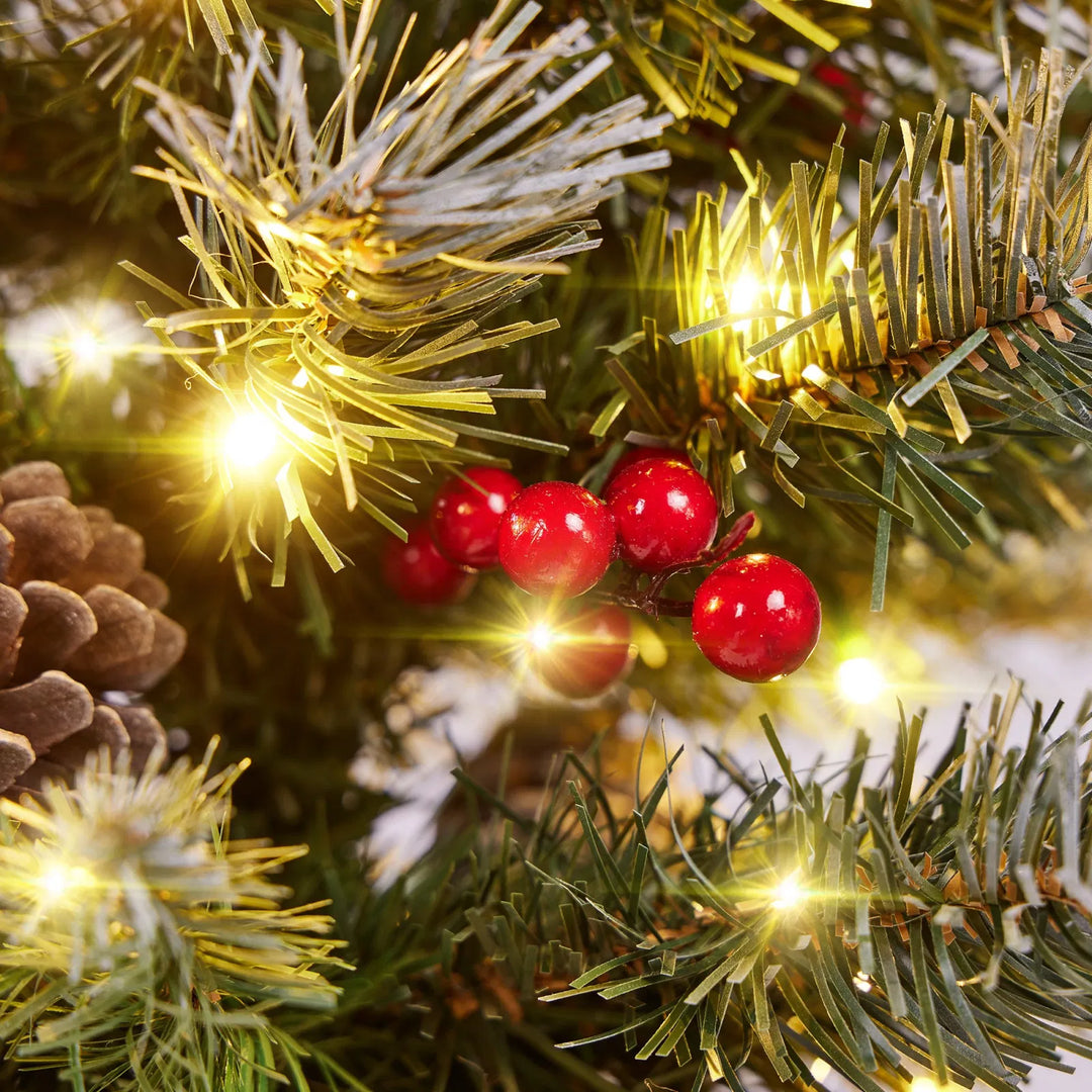 Two frosted tabletop trees with burlap bases