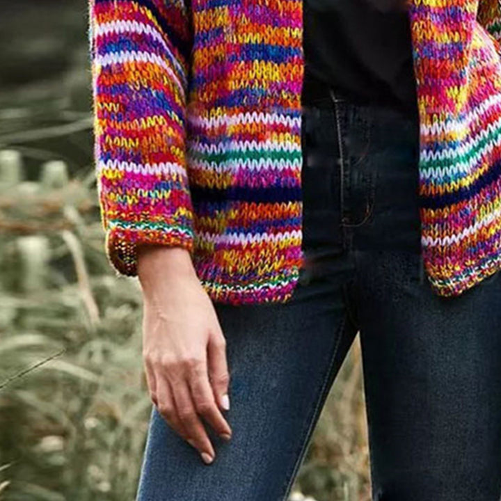 Woman in chunky rainbow striped knit cardigan