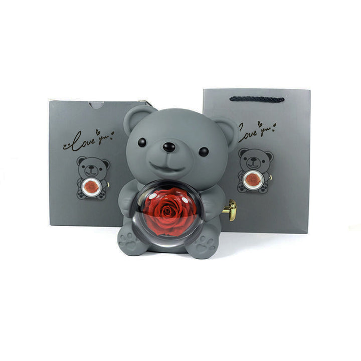 Rotating teddy bear jewellery box with eternal rose