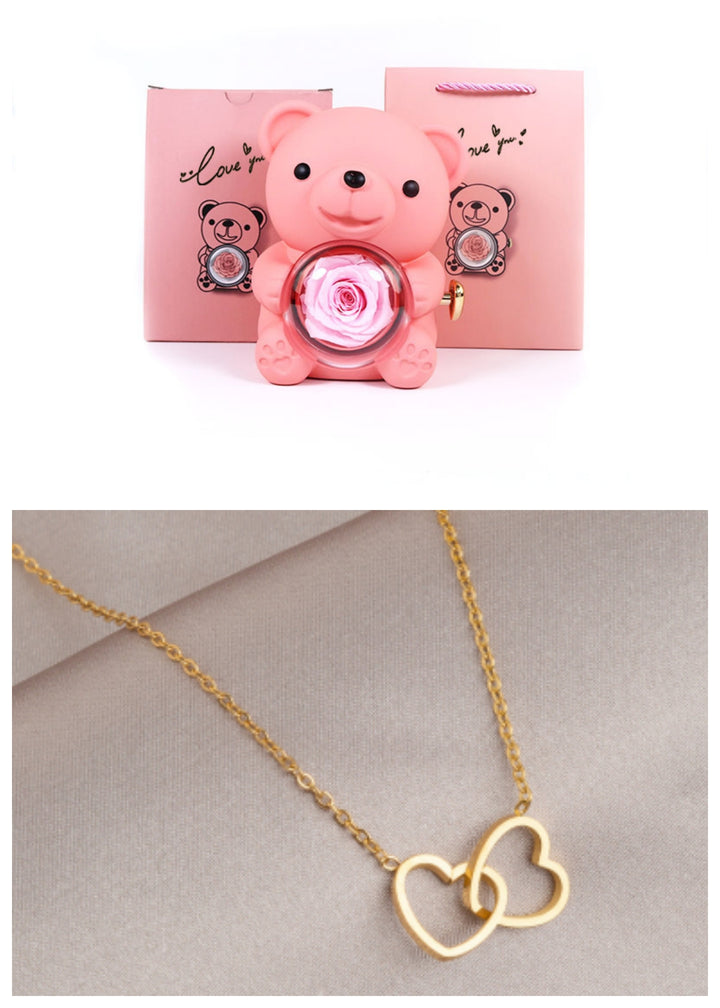 Rotating teddy bear jewellery box with eternal rose