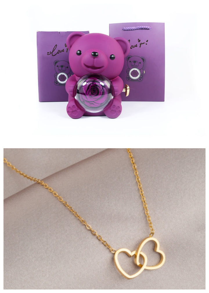 Rotating teddy bear jewellery box with eternal rose