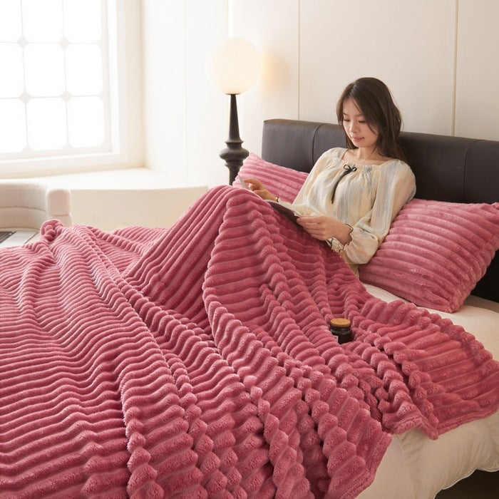 Dusty rose ribbed faux fur blanket on bed