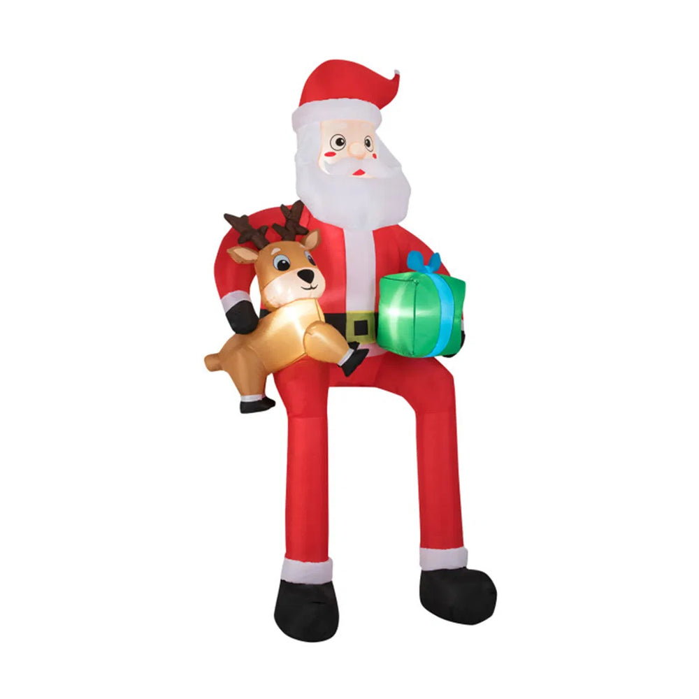 Giant inflatable Santa sitting with reindeer