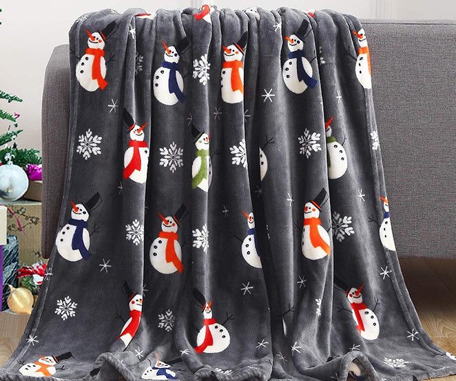 Christmas fleece throw blanket on a sofa