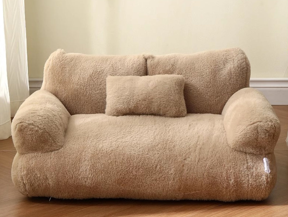 Cat lying on plush pet sofa with pillow