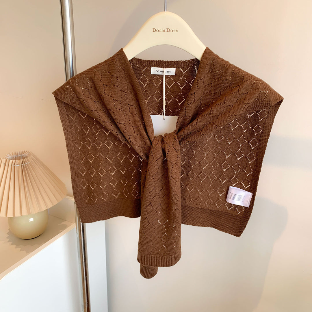 Woman wearing knitted tie front shoulder wrap