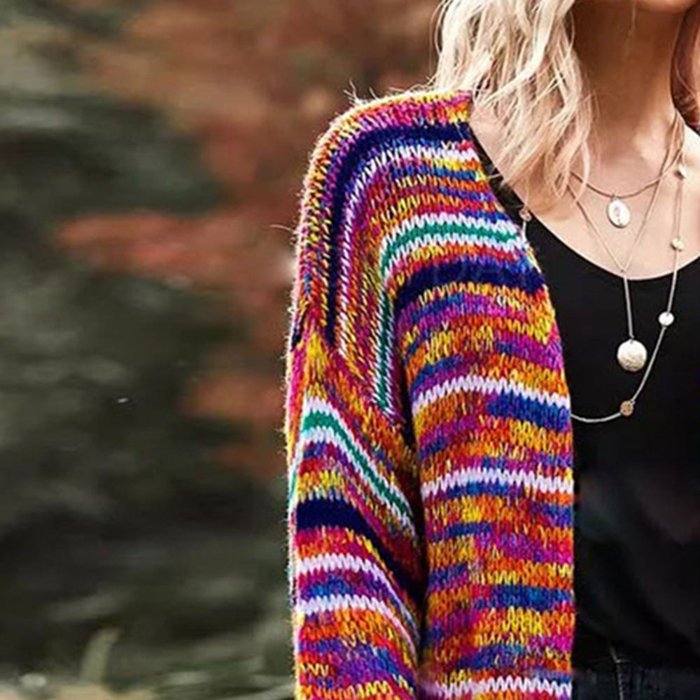 Woman in chunky rainbow striped knit cardigan