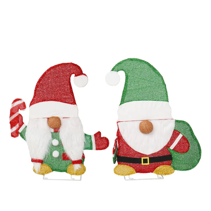 Two lit Christmas gnome figures in garden