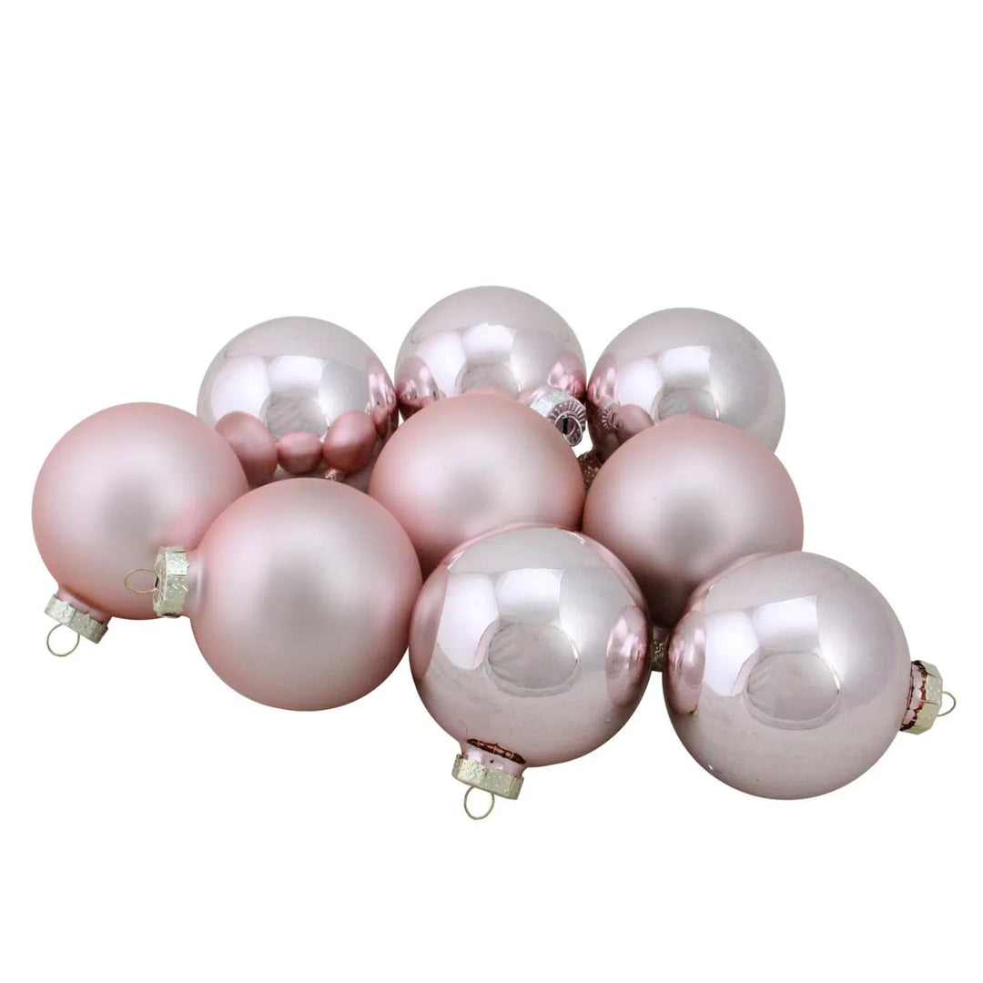 Nine pink glass Christmas baubles with gold caps