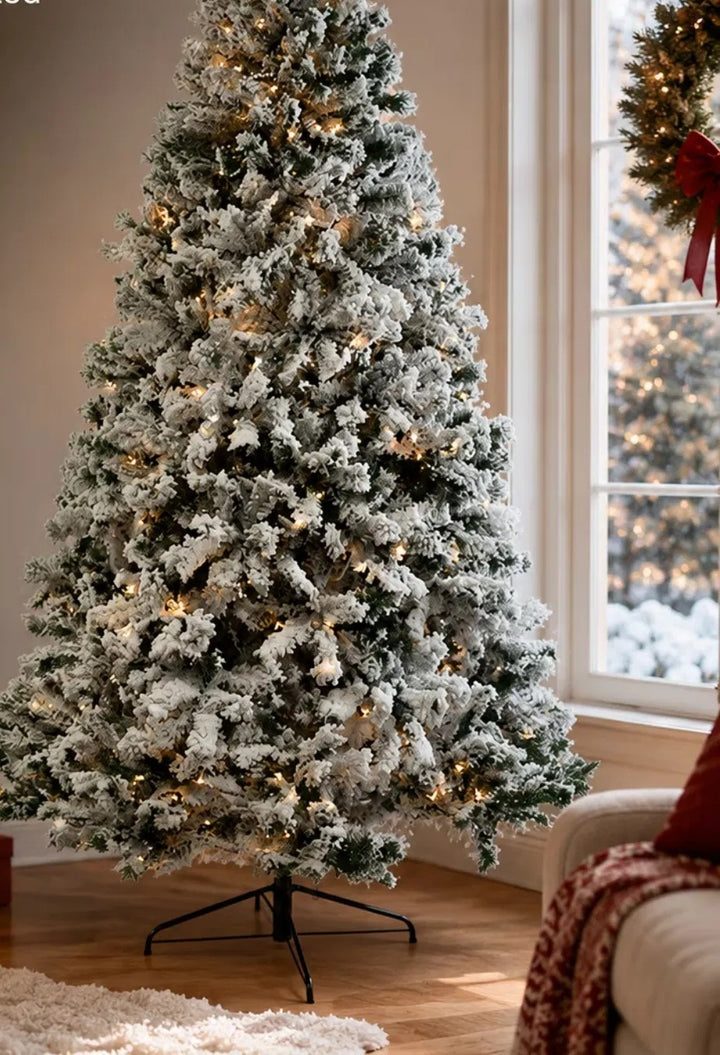 Snow-flocked pre-lit tree glowing white
