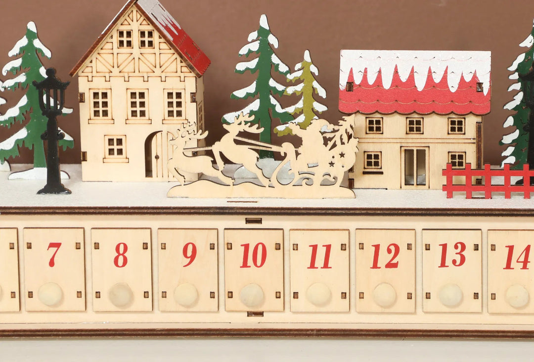 Long wooden lit advent calendar on mantel