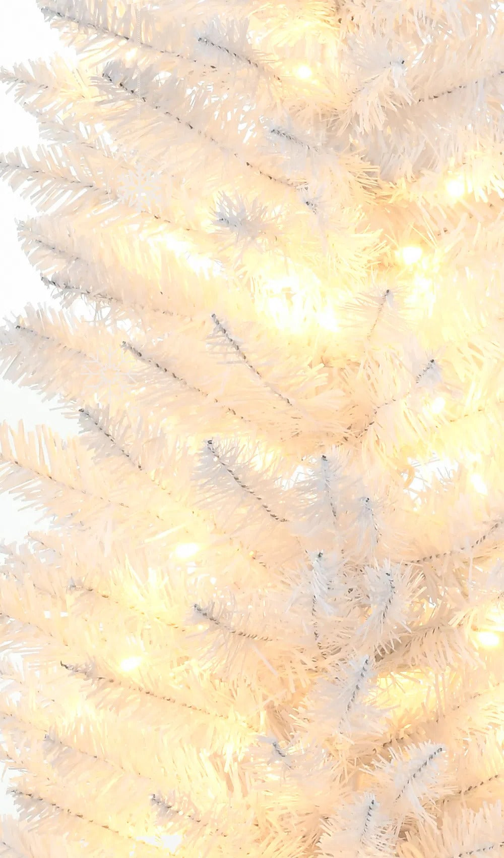 White slim pencil tree with warm lights