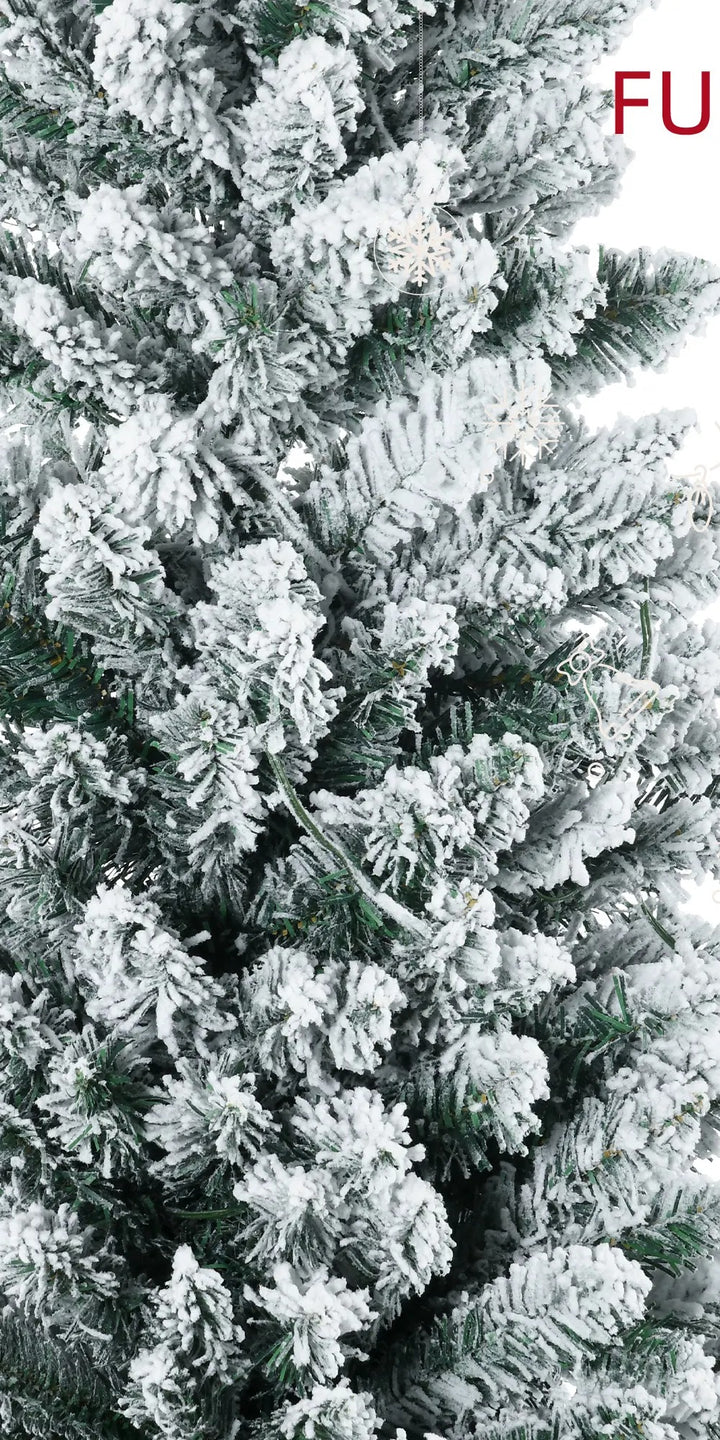 Snowy flocked pencil tree with warm lights