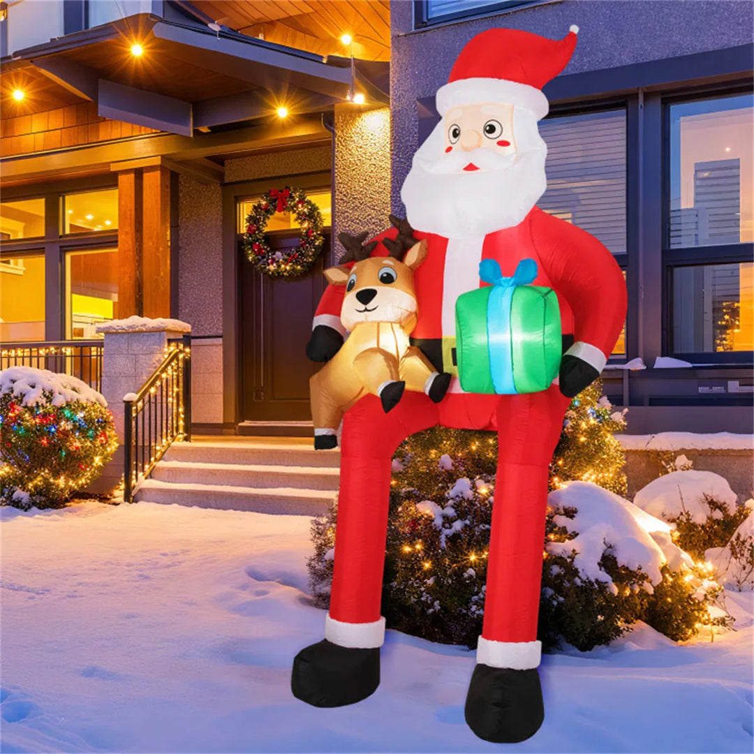 Giant inflatable Santa sitting with reindeer