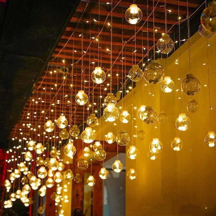 Warm white LED orb curtain lights in window