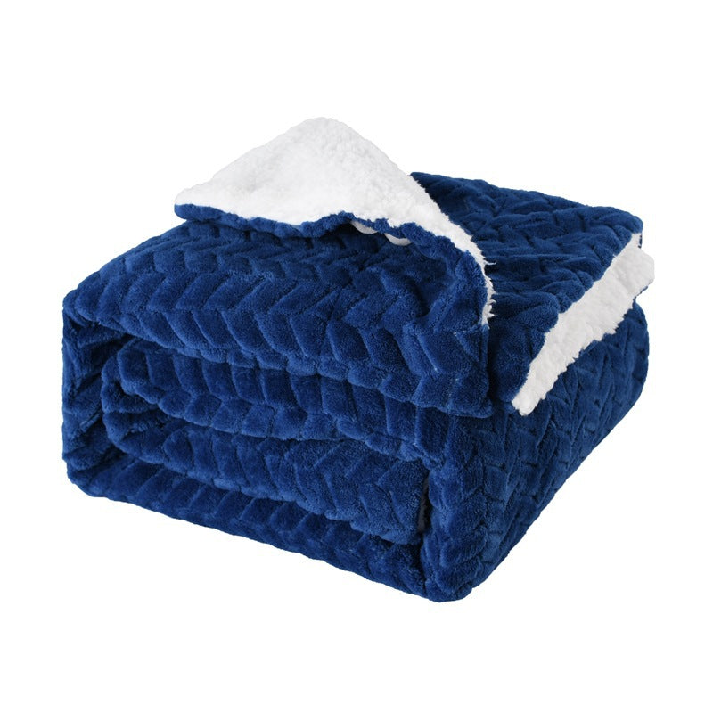 Thick sherpa blanket folded on a sofa