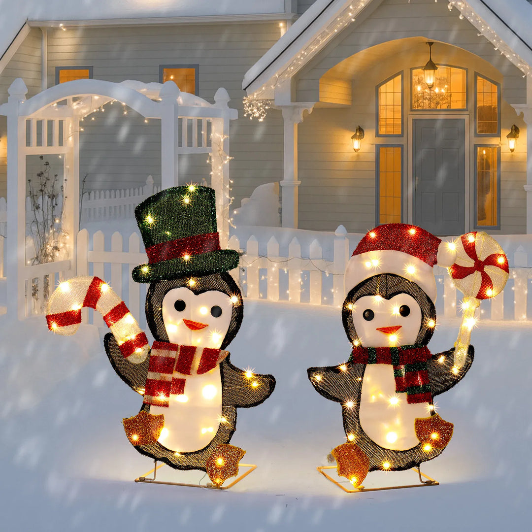 Two light-up Christmas penguins with candy canes
