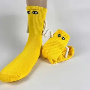 Two socks with magnetic hands holding each other