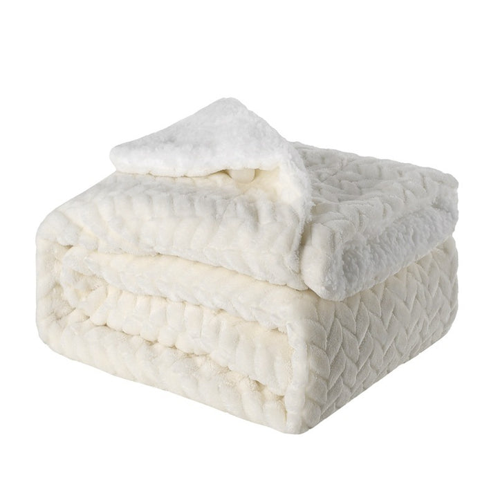 Thick sherpa blanket folded on a sofa