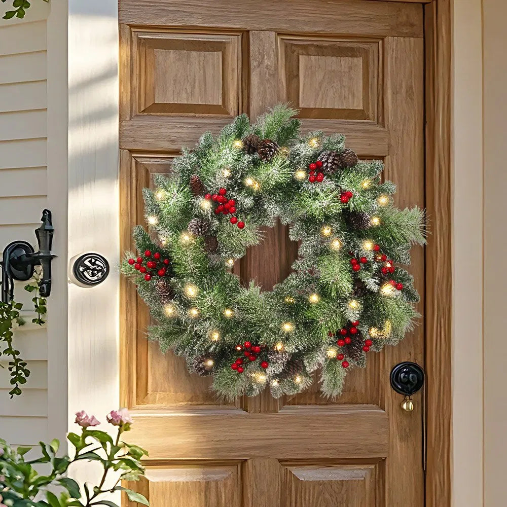 Lit wreath with pine cones and red berries