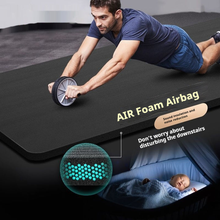 Thick grey exercise mat rolled with carry strap