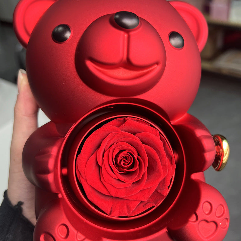 Rotating teddy bear jewellery box with eternal rose