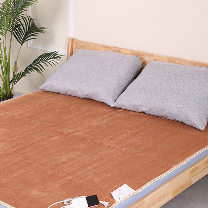 Brown flannel electric under blanket on bed